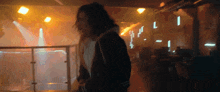 a blurry picture of a man in a dark room with the letter l in the background