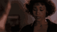 a man and a woman are looking at each other . the woman is wearing earrings .