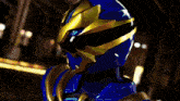 a blurred image of a blue and gold costume