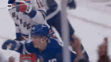a hockey player with the number 10 on his jersey is being tackled