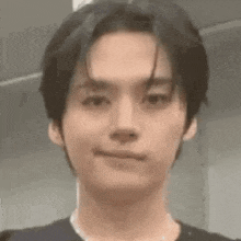 a close up of a person 's face with a slight smile on their face .