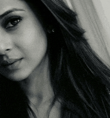 a black and white photo of a woman with long dark hair