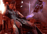 a man with horns is sitting in a chair holding a purple object in his hand