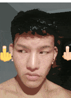 a man with a middle finger on his ear looks at the camera