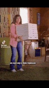 a woman is carrying a stack of pizza boxes and says we just got 6 free tiernans