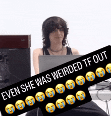 a woman sitting in front of a laptop with a sign that says " even she was weirded tf out " on it