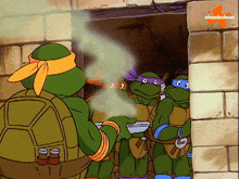 a group of teenage mutant ninja turtles standing in front of a brick wall with a nickelodeon logo in the corner