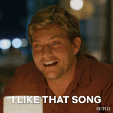a man sitting at a table with the words " i like that song " below him