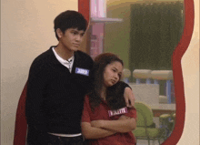 a boy and a girl are standing next to each other with the girl wearing a red shirt that says iolette