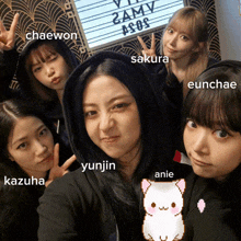 a group of girls are posing for a picture and one of them has the word anie on her shirt