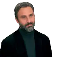 a man with a beard is wearing a black jacket and a black turtleneck