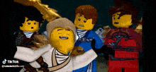 a group of lego ninjago characters are standing next to each other