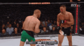 two men are fighting in a ufc ring with a t-mobile arena advertisement in the background