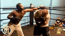 a man wearing a black shirt that says title is standing in a boxing ring