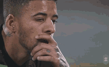 a man with a tattoo on his neck has the word fe on it