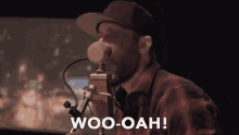 a man singing into a microphone with the words woo-oah written below him