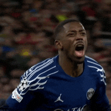 a soccer player wearing a blue jersey with a jordan logo on it