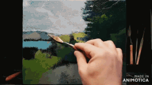 a person is painting a picture with the words made in animotica on the bottom right