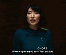 a woman in a blue dress is talking to someone and says `` please try to enjoy each feet equally . ''