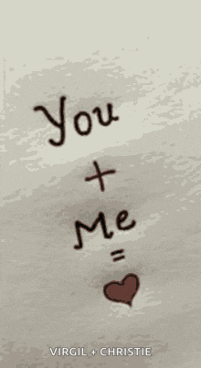 a sign that says " you + me " with a heart in the middle