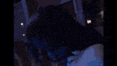 a close up of a woman 's face with red eyes