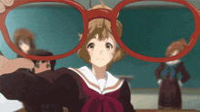 a girl is holding a pair of red glasses in front of her face