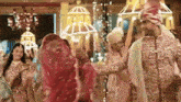 a bride and groom are dancing together in a room with a lot of lights .