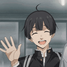 a boy with black hair and a smile on his face is waving his hand
