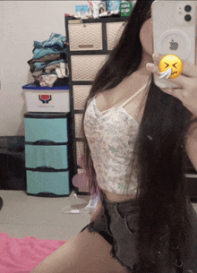 a woman taking a selfie with a phone that has an apple logo on it