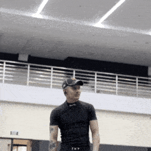 a man wearing a black shirt with the word 7ky on it