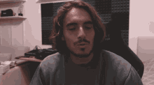 a man with long hair and a beard is wearing a shirt that says " et hb " on it