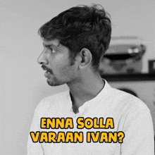 a man in a white shirt with the words enna solla varaan ivan
