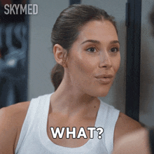 a woman in a white tank top says what in black letters