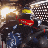 a person wearing a helmet that says hendrick racing on it