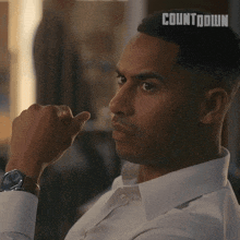 a man in a white shirt has the word countdown on his forehead