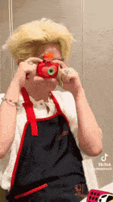 a person is taking a picture of themselves with a toy camera .