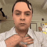 a man wearing a striped shirt has his hand on his chest and the word that is above him