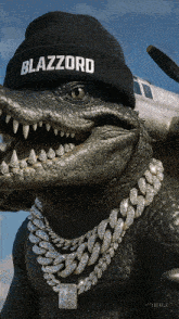 a statue of a crocodile wearing a black beanie that says blazzard