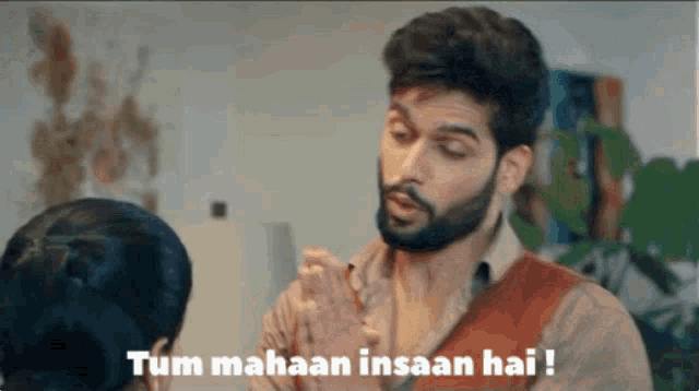 a man with a beard talks to a woman and says tum mahaan insaan hai !
