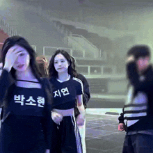 a woman wearing a black crop top with chinese writing on it