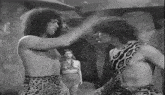 a man in a leopard print shirt is standing next to another man in a leopard print shirt .
