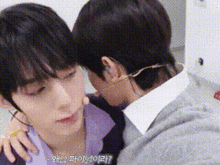 two young men are hugging each other and one of them is wearing a mask .