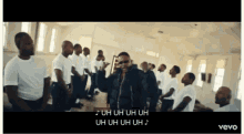 a group of men are standing in a room with the words uh uh uh uh written on the screen