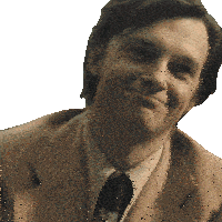 a man in a suit and tie is smiling with a white background