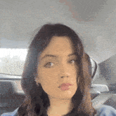 a woman is sitting in the back seat of a car .