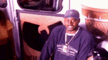 a man wearing a hat and a sweater that says london