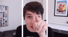 a man is making a funny face and pointing at the camera with his finger .