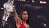 two women are wrestling in a ring with the word wrestling on the ring .