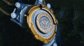 a close up of a gold and silver object with a circle on it .
