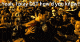 a man in a superman costume is surrounded by a crowd of people and says yeah i play dst